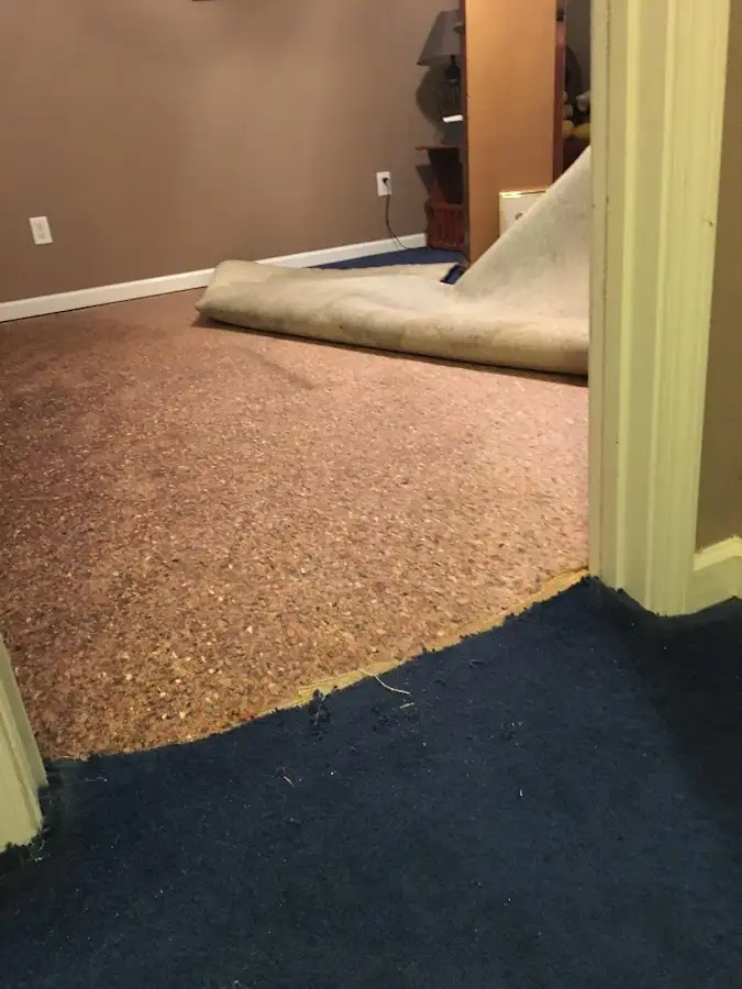Carpet pad removal revealing water damage during Water Mitigation Services in East Hills
